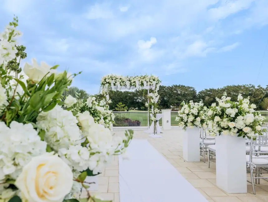 A wedding ceremony set with white flowers on the terrace
