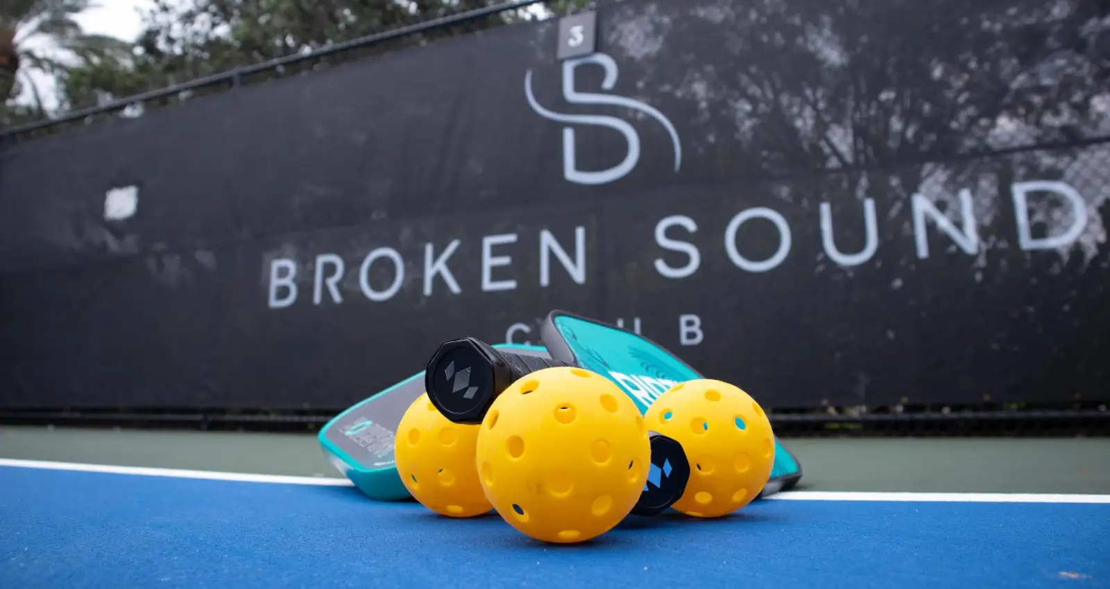 Pickleball paddles and balls at the court